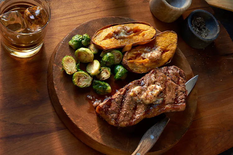 Strip Steaks and Sweet Potatoes with Bourbon-Pecan Butter | Red Meat Recipes | Weber Grills