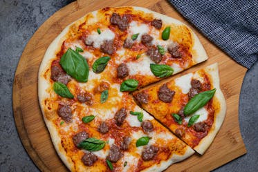 Tomato, Beef Sausage And Mozzarella Pizza With Basil